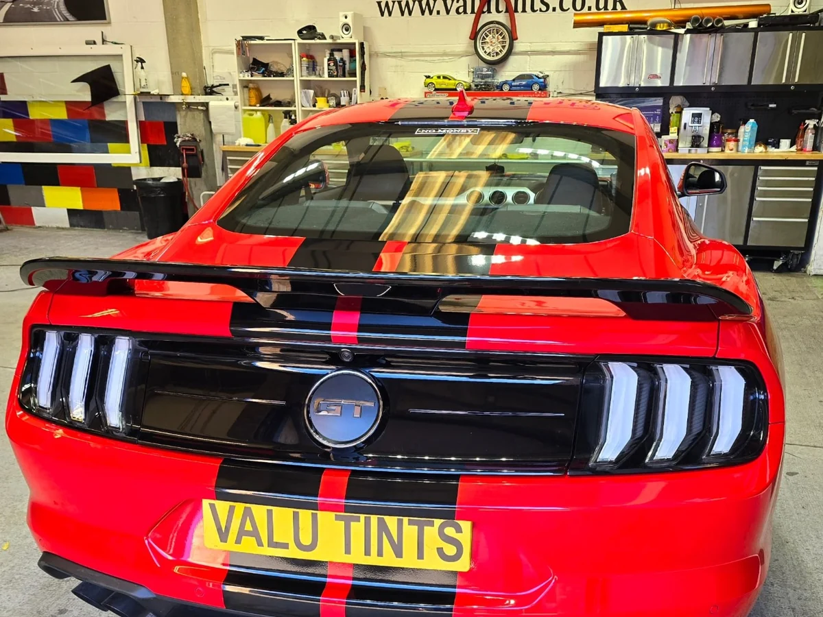Red Ford Mustang with black racing stripe styling at Valu Tints