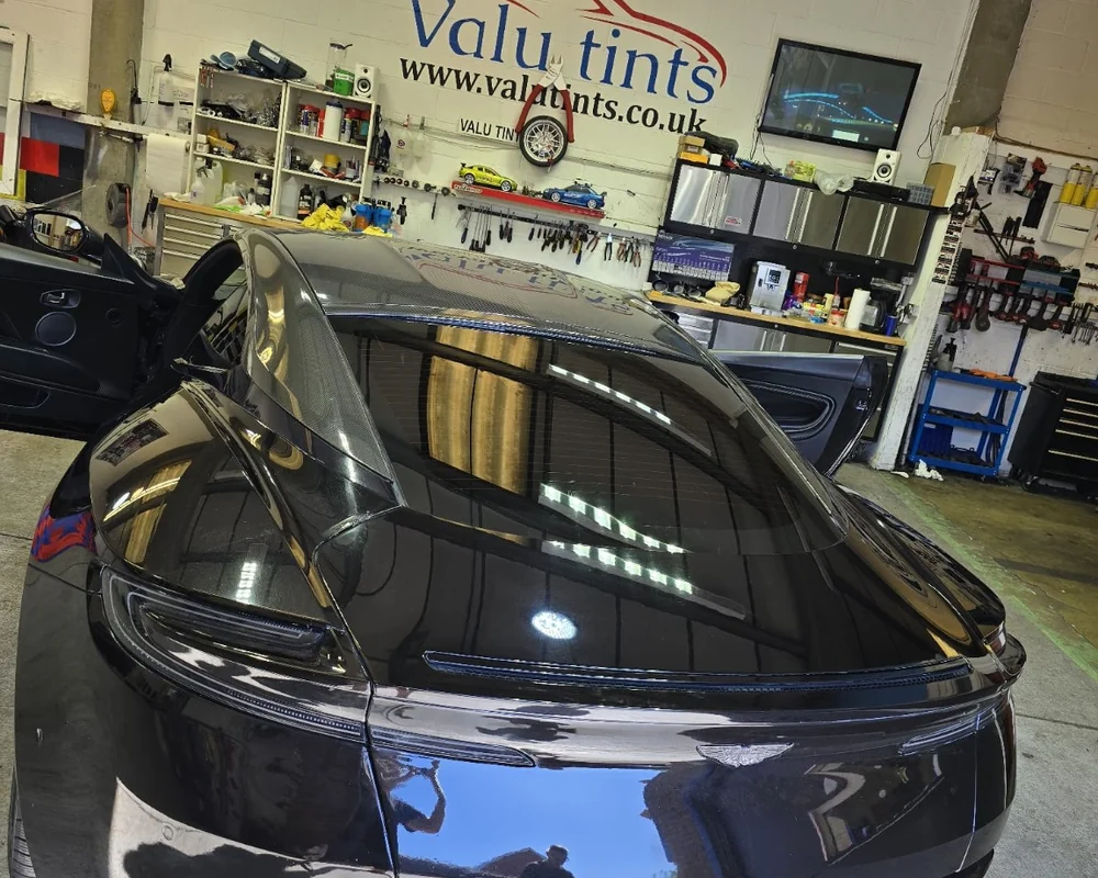 Dark Aston Martin styling work inside the Valu Tints workshop