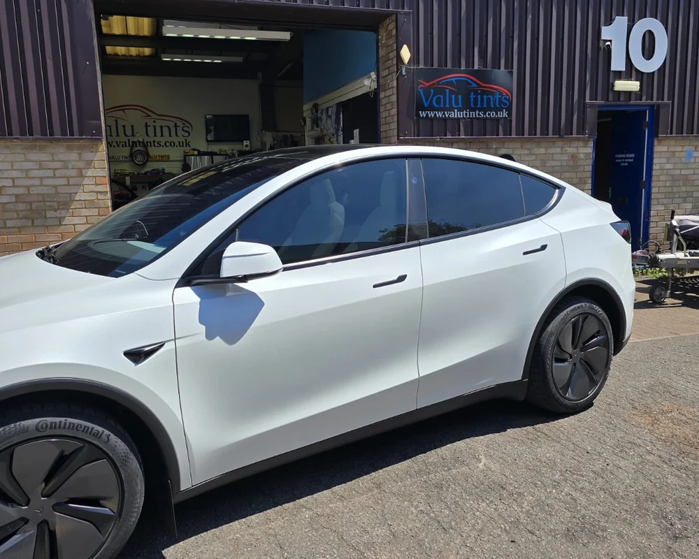 White Tesla with tinted windows outside Valu Tints